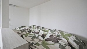 A bedroom with a bed, a nightstand, and a white wall. - SHITAMACHI BASE/Quiet new apt.room101/skytree view (東京)