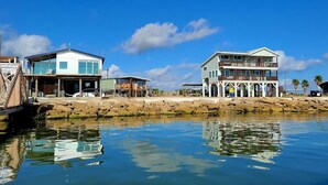 A coastal property with a dock, a pier, and a beachfront view. - SUNRISE ON MAG - Beach House (Port Lavaca)
