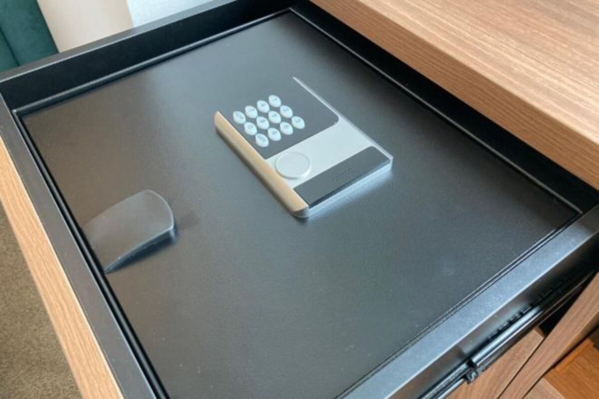 A drawer with a remote control inside.