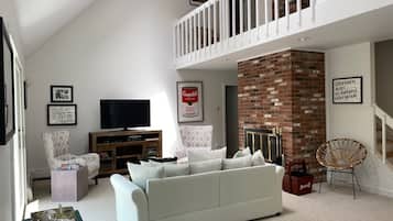 TV, fireplace, books