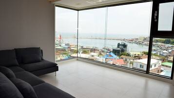 Condo, 2 Bedrooms (C-401) | Living room | Flat-screen TV
