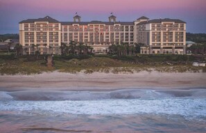 A multi-story hotel with a symmetrical facade, multiple balconies, and a beachfront location. - BREATHTAKING VIEWS! 4th Floor Oceanfront Condo next to Ritz Carlton! (Fernandina Beach)
