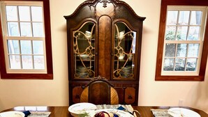 A dining table with a central decorative piece, surrounded by plates and placemats.