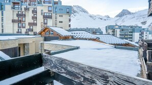 A modern building with multiple balconies and a wooden structure on the roof. - Beautiful apartment for 6 guests with WIFI and balcony (Les Boisses)
