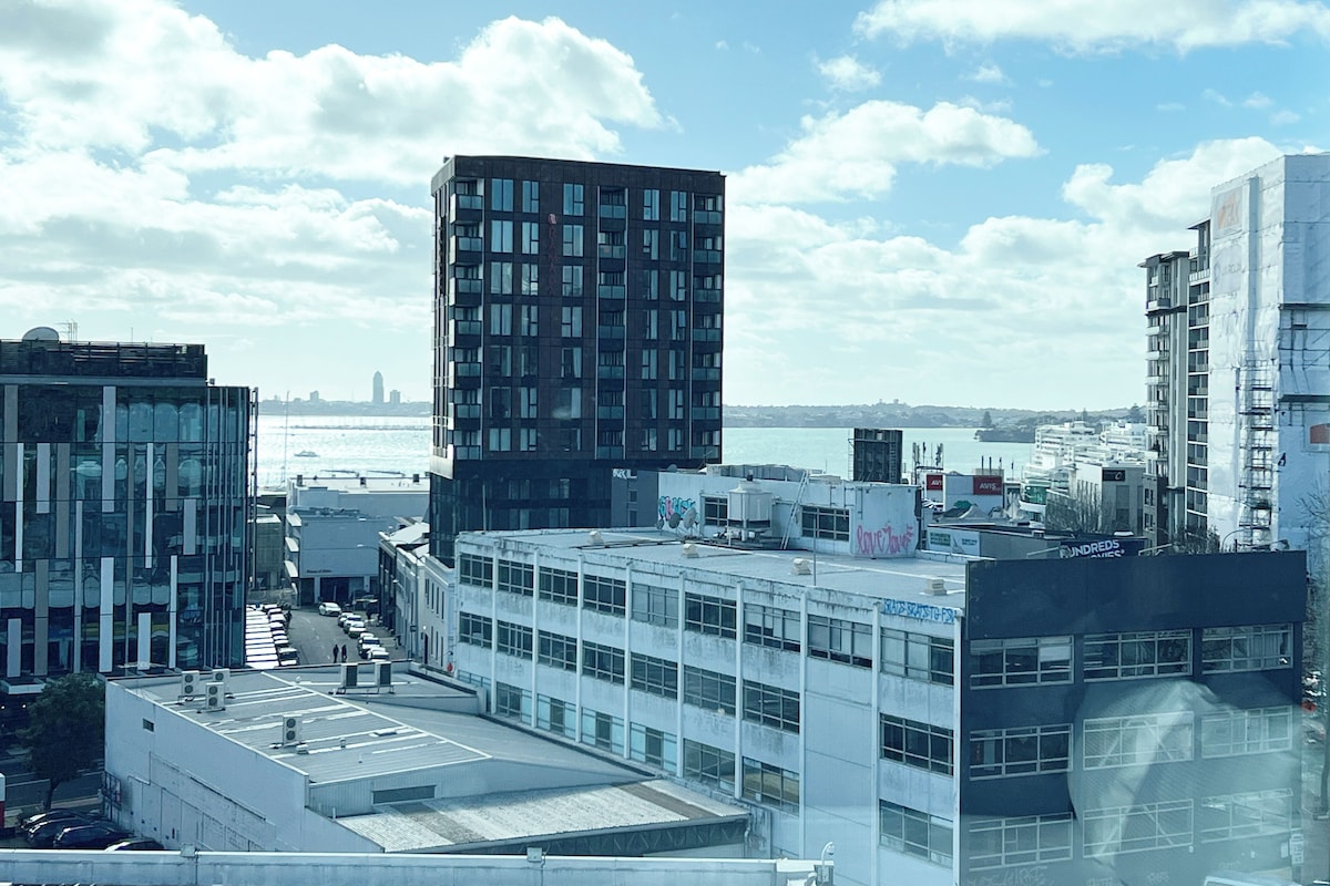 A high-rise building with a modern architectural design, featuring multiple windows and a flat roof.