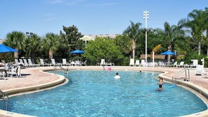 A swimming pool with lounge chairs and umbrellas, surrounded by palm trees and a clear sky. - Ev7836ha - Bahama Bay Resort - 3 Bed 2 Baths Condo (Davenport)
