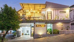 A two-story building with a covered entrance and a signboard. - Penginapan Pugeran - Hostel (Yogyakarta)