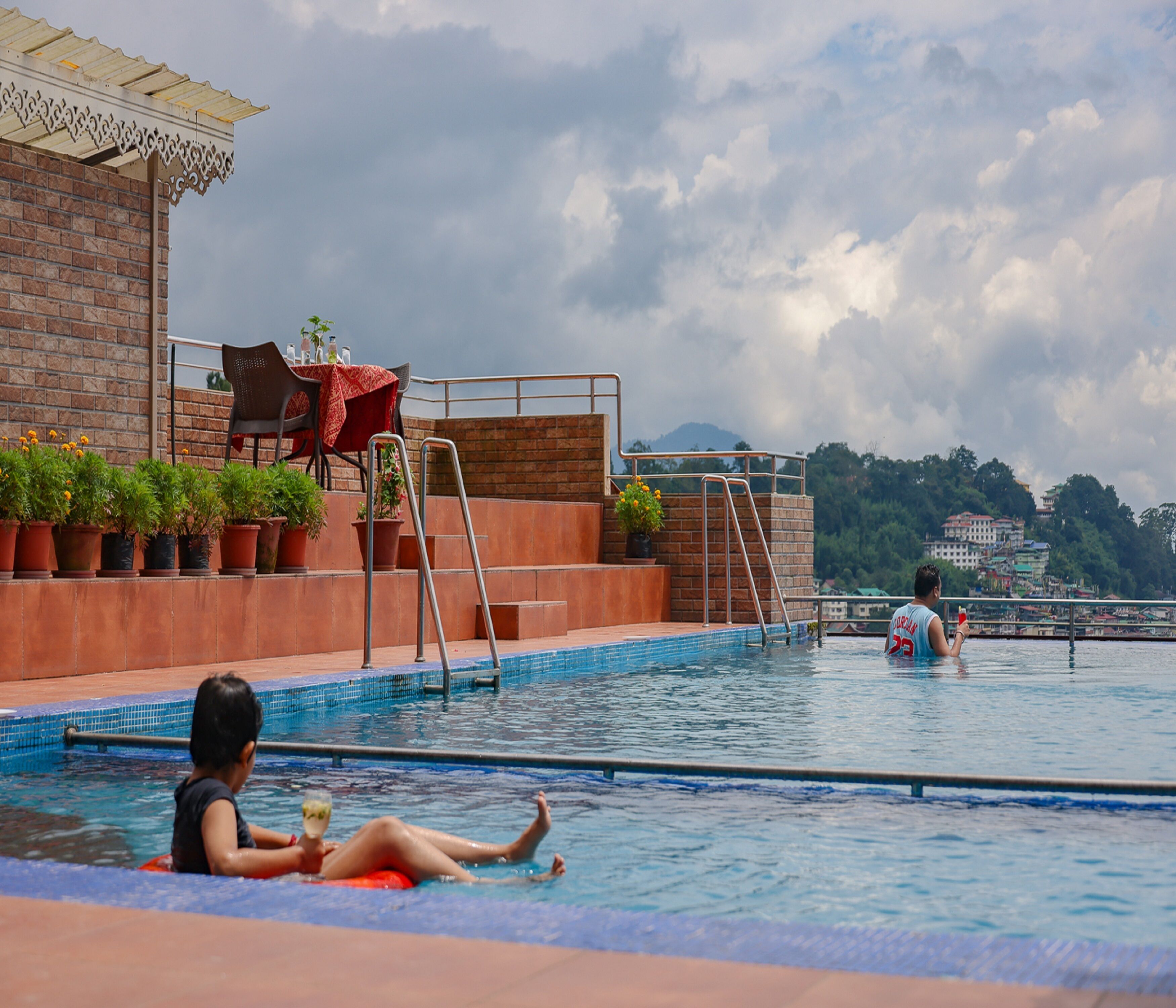 A swimming pool with a view of a cityscape in the background.