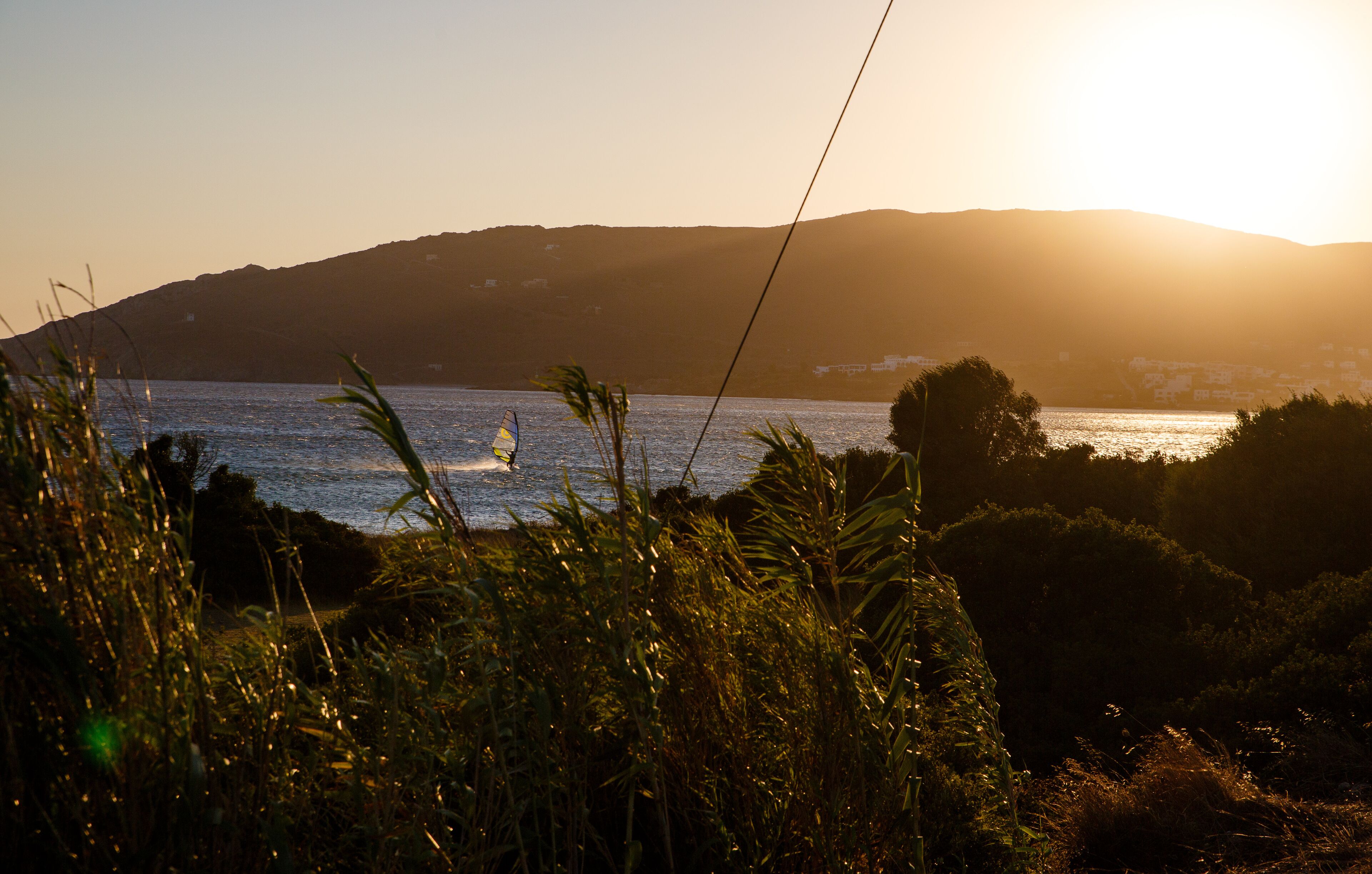 A coastal landscape with a view of the sea and hills in the background.