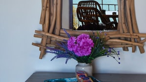 A rustic wooden frame with a view of the sea and a chair outside. - Areos Galaxy Apartments With Beach View (Spata-Artemida)