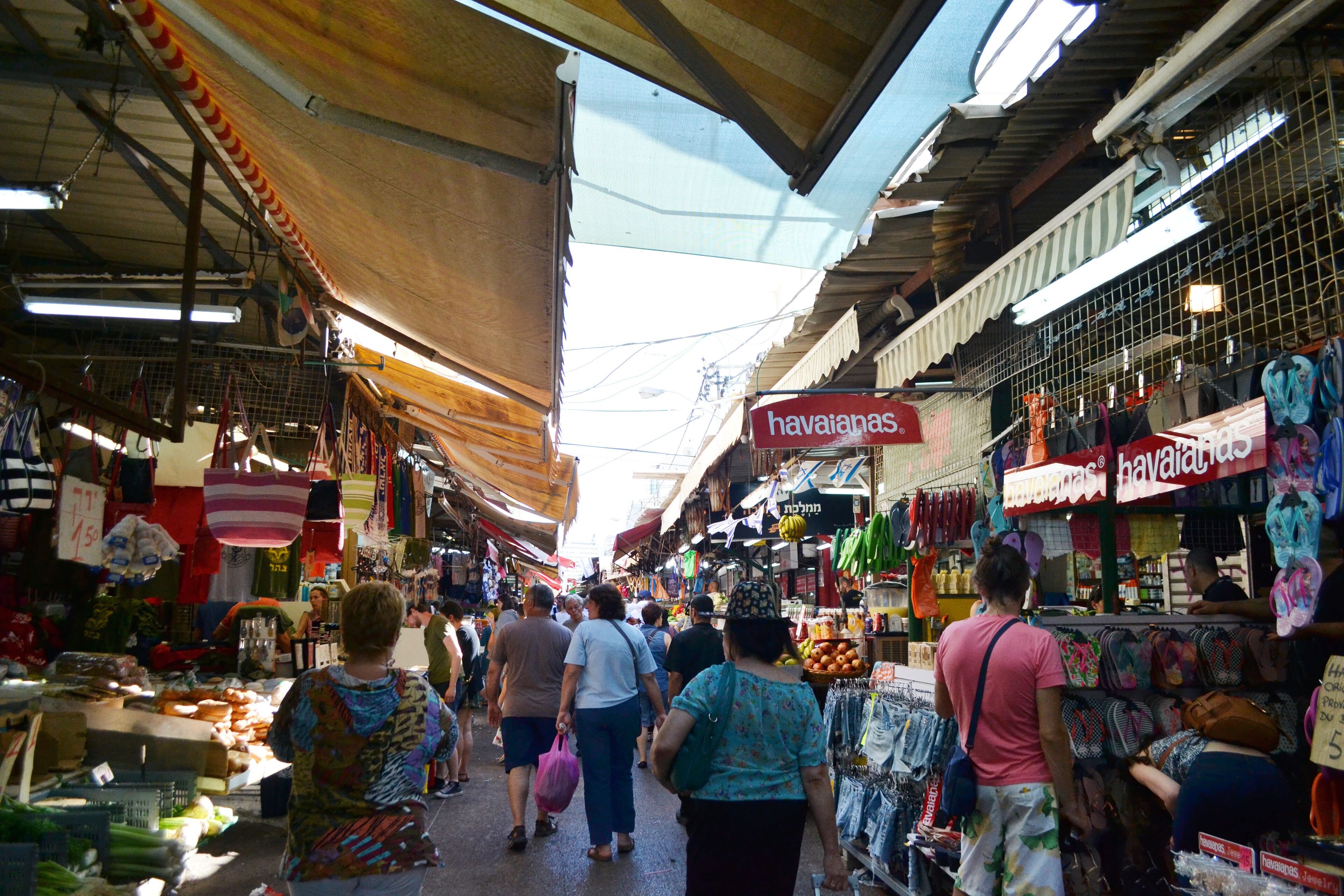 An indoor market with various stalls selling goods.