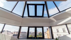 Una habitación con tragaluces y ventanas amplias que ofrecen vistas a la ciudad.