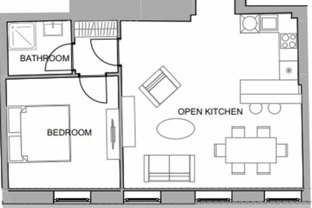 A floor plan with a bedroom, bathroom, entry room, toilet, and open kitchen.