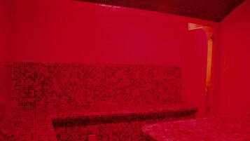 Experience the vibrant atmosphere of this stylish room, featuring a unique red mosaic tile design throughout.