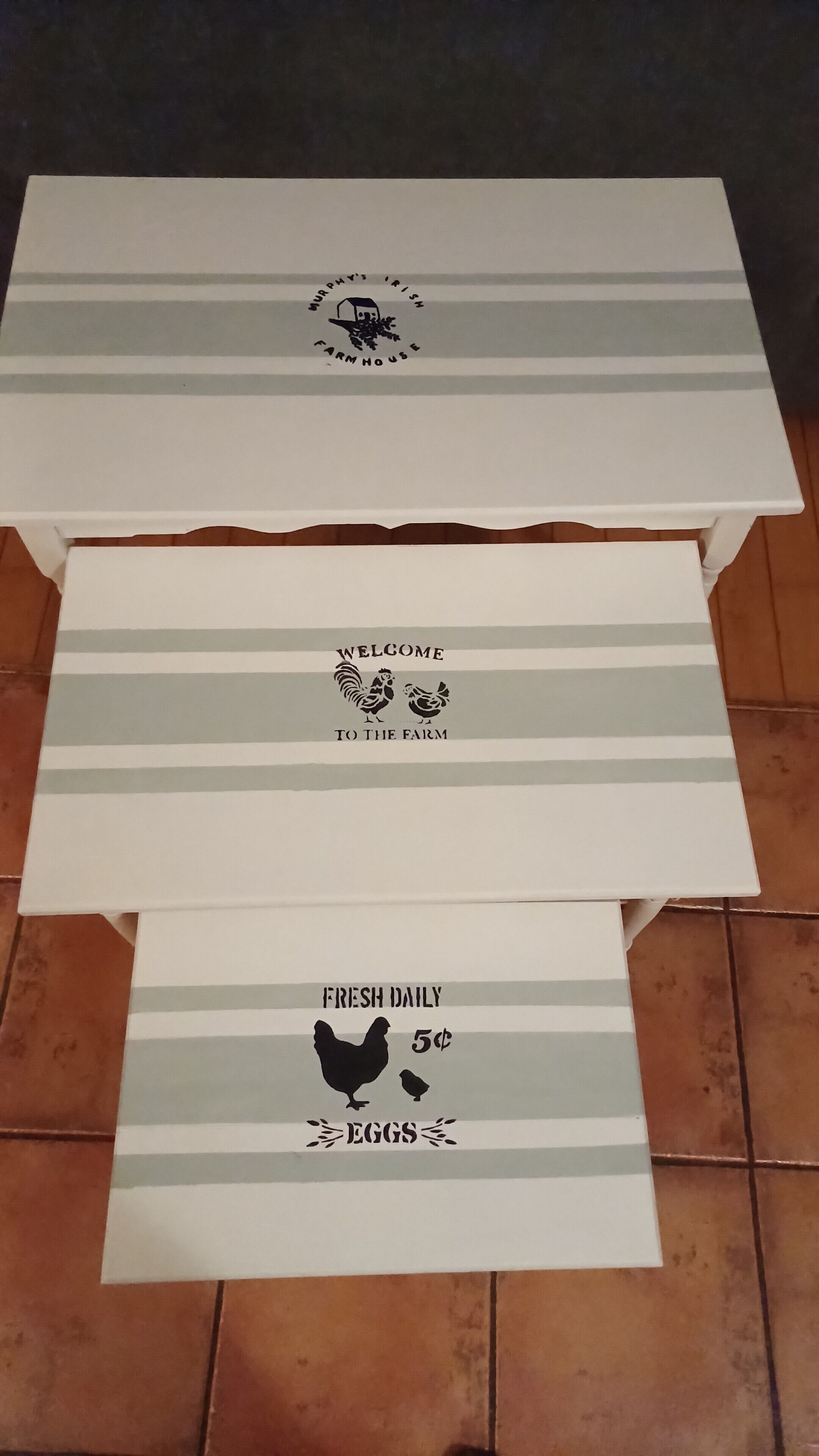 Three white boxes with grey stripes and text. The top box has a logo and text 'Murphy's Irish Farmhouse'. The middle box says 'Welcome to the Farm'. The bottom box displays 'Fresh Daily Eggs 5¢'.
