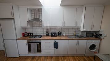 Luxury Apartment | Private kitchen | Full-size fridge, microwave, oven, stovetop