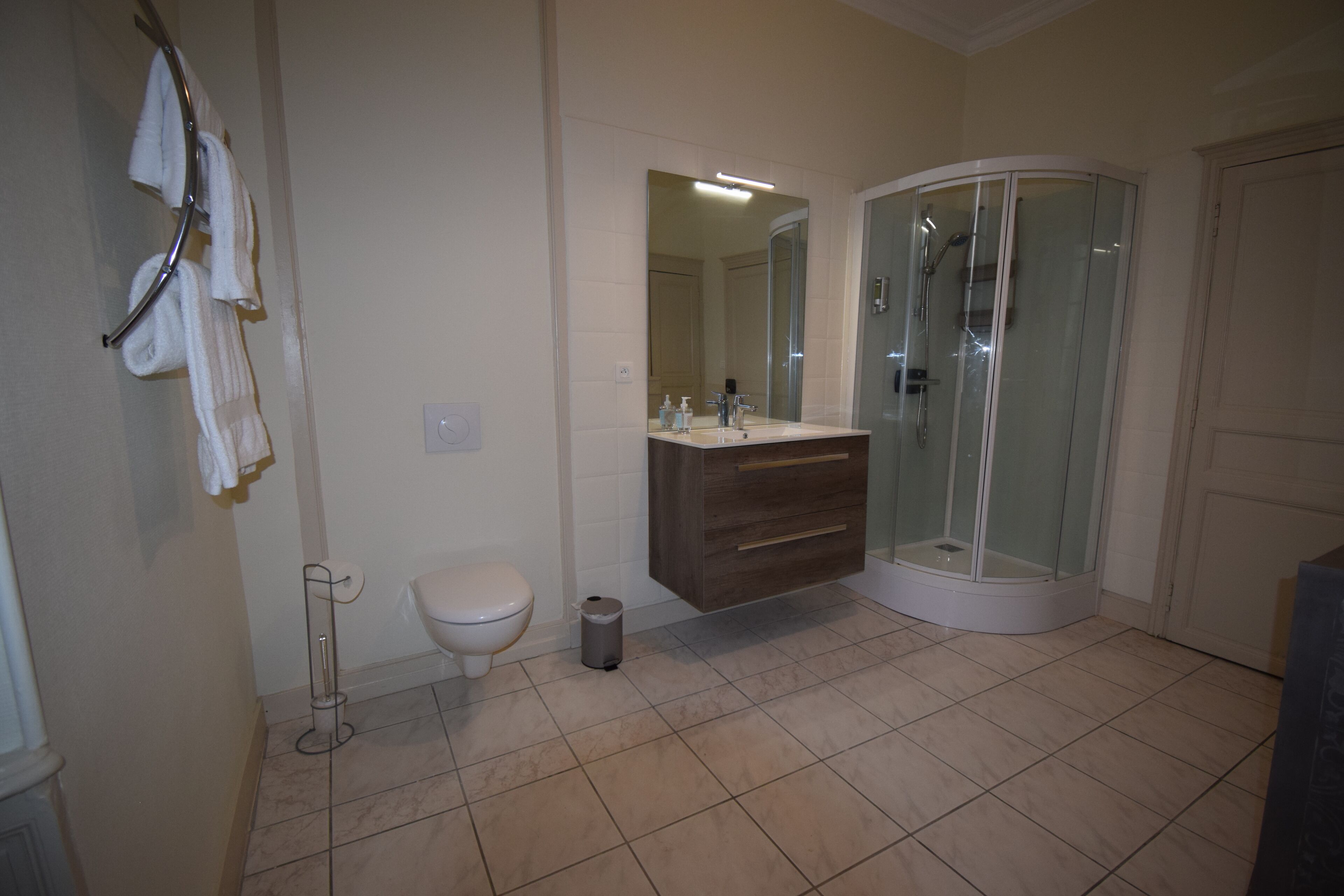 A bathroom with a toilet, sink, and shower.