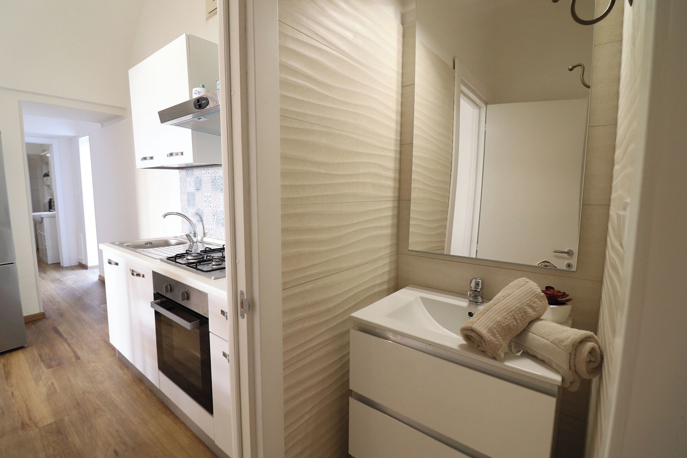 A modern kitchen with a built-in oven and a sink.