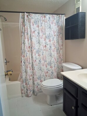 A bathroom with a shower, toilet, and a sink. - Atalaya Towers 103 - Oceanfront in Garden City Beach (Garden City)
