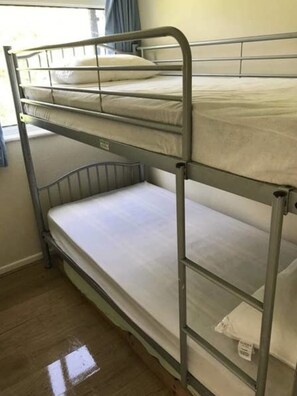Cozy sleeping quarters feature a two-level bunk bed with a window above.