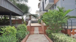 A residential building with a covered walkway and steps leading to a door. - Denami Suites (Port Harcourt)