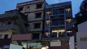 A multi-story building with the sign "PUNEST HOSPITALITY A/C Room" indicating it is a hotel. - Punest Hospitality & Hotel (Pune)