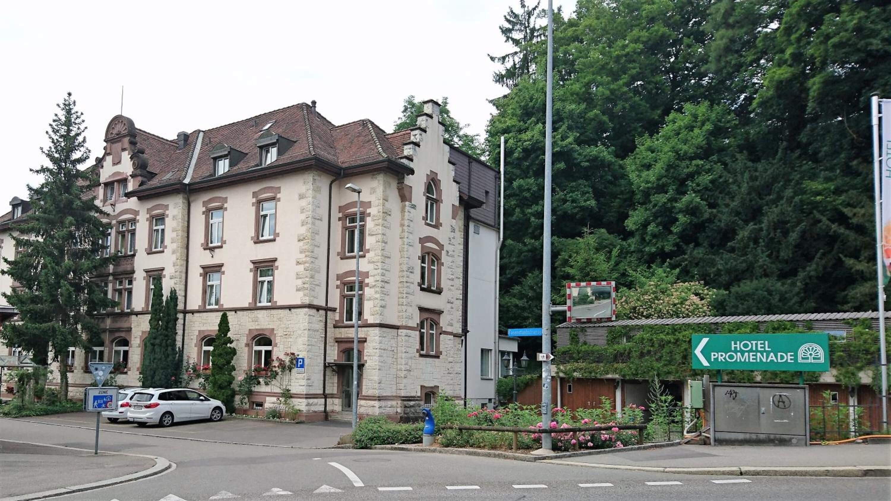 A historic building with a stone facade, multiple windows, and a traditional roof.