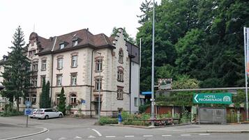 A historic building with a stone facade, multiple windows, and a traditional roof.