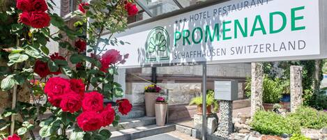 A hotel entrance with a sign reading "Hotel Restaurant Promenade Schaffhausen Switzerland".
