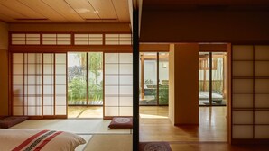 A traditional Japanese-style room with tatami flooring, sliding doors, and a view of a garden. - Villa 32 (Taipei)