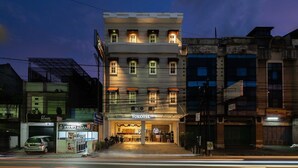A multi-story building with a prominent entrance labeled "Yokotel." - Yokotel Hotel (Bandung)