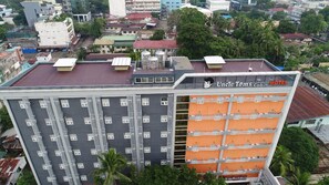 A multi-story building with a prominent Uncle Tom's Cabin Hotel sign, featuring a modern design with balconies and a rooftop area. - Uncle Tom's Cabin Hotel (Cebu City)