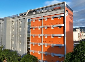 A multi-story building with a prominent orange facade and a sign reading 'Uncle Tom's Cabin Hotel.'