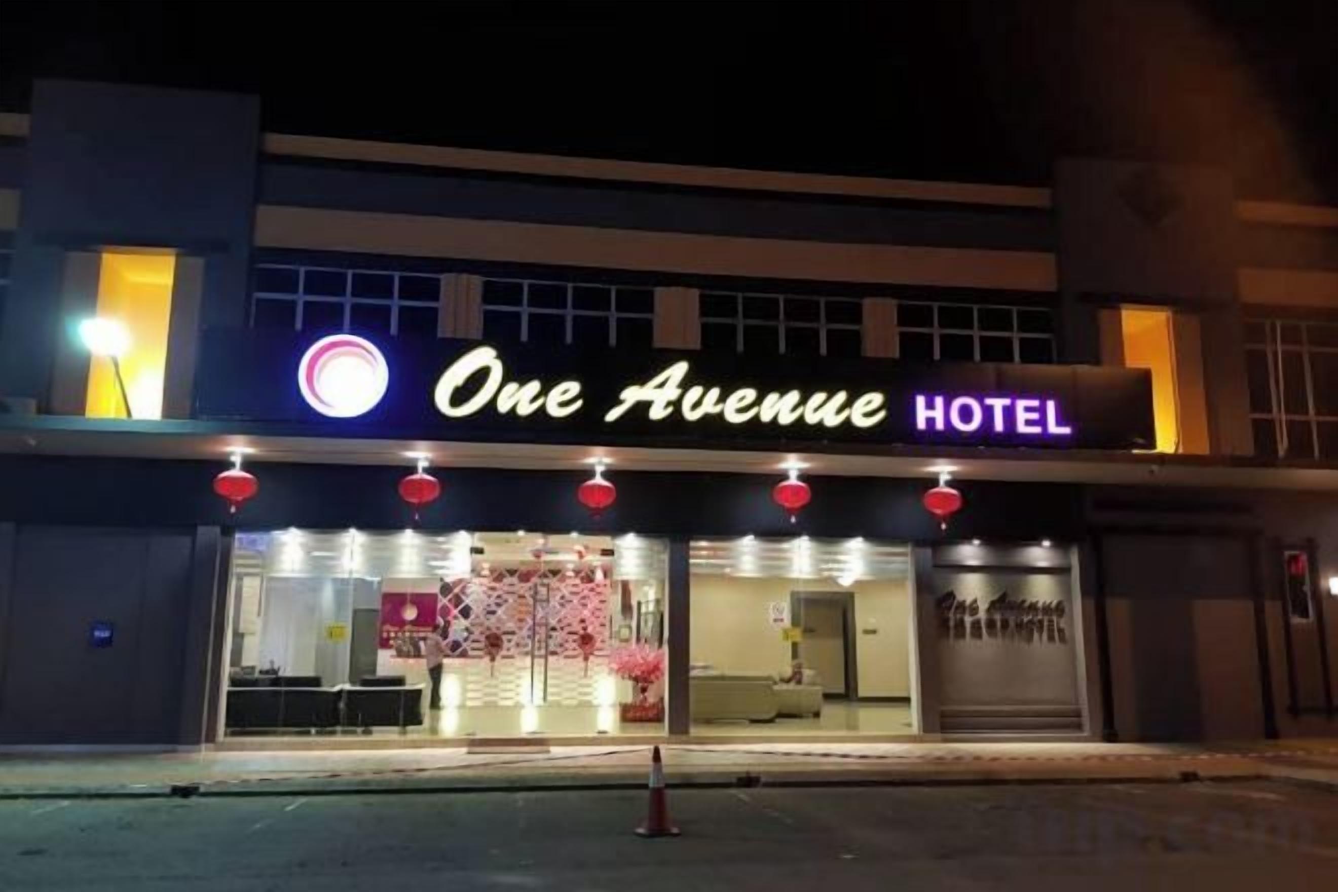 A hotel named 'One Avenue Hotel' with a visible entrance and a signboard.