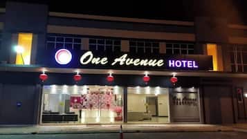 A hotel named 'One Avenue Hotel' with a visible entrance and a signboard.