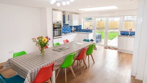 A modern kitchen with a dining area. - Romney House (Hythe)