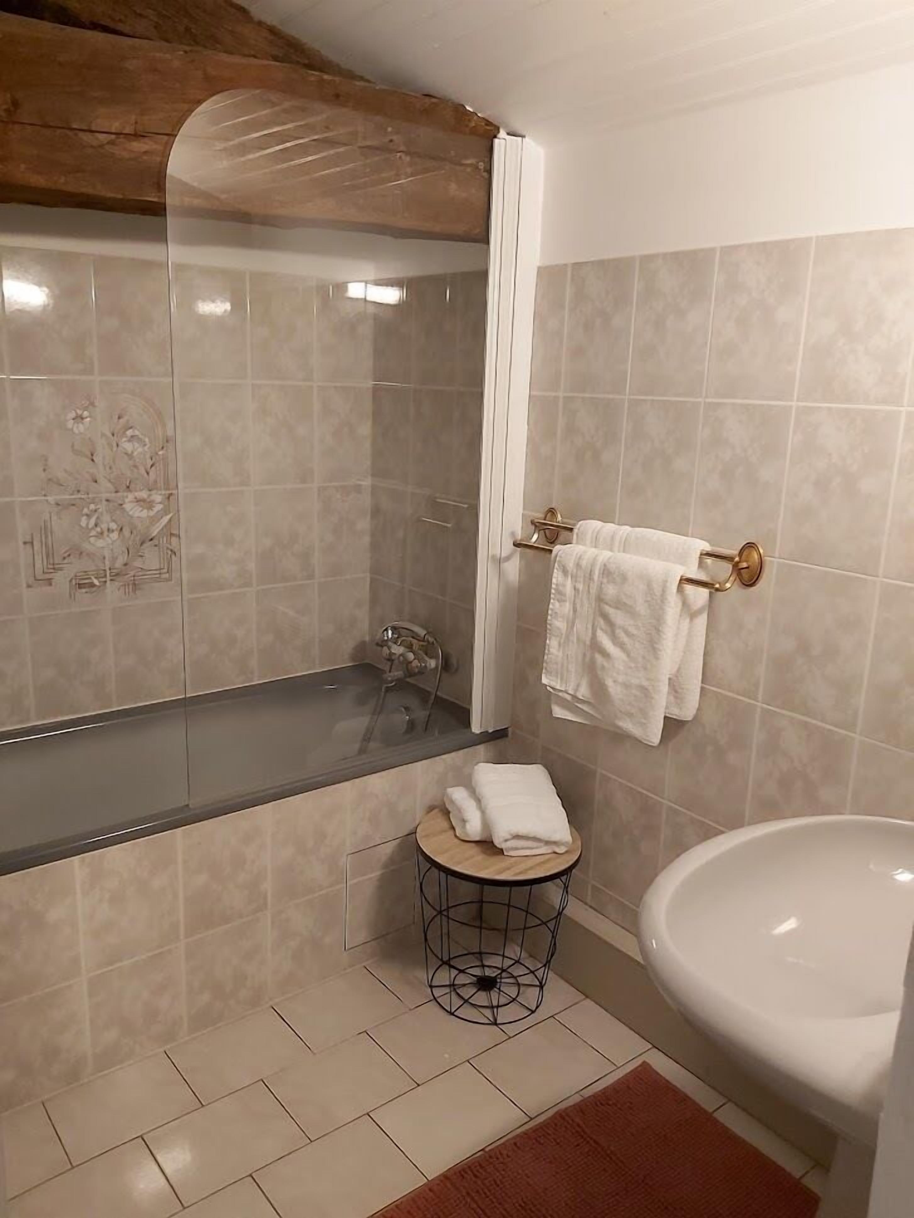 A bathroom with a bathtub, a sink, and a toilet.