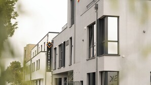 A modern building with a sign reading "JUST STAY". - JustStay Grevenbroich Hotel & Apartments (Grevenbroich)