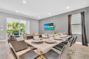 Dining Extravaganza: Indulge in the opulence of our dining area, where the combination of lavish design and gourmet delights creates an extravagant dining experience. - Pool Home! 5BR w Patio & Free Parking near Disney (Kissimmee)