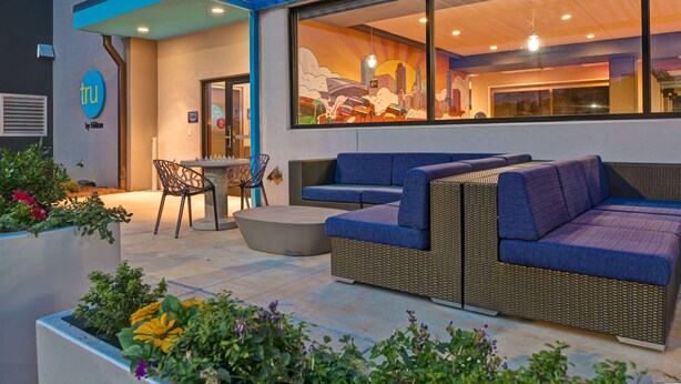An outdoor seating area with wicker furniture, a dining table, and chairs.