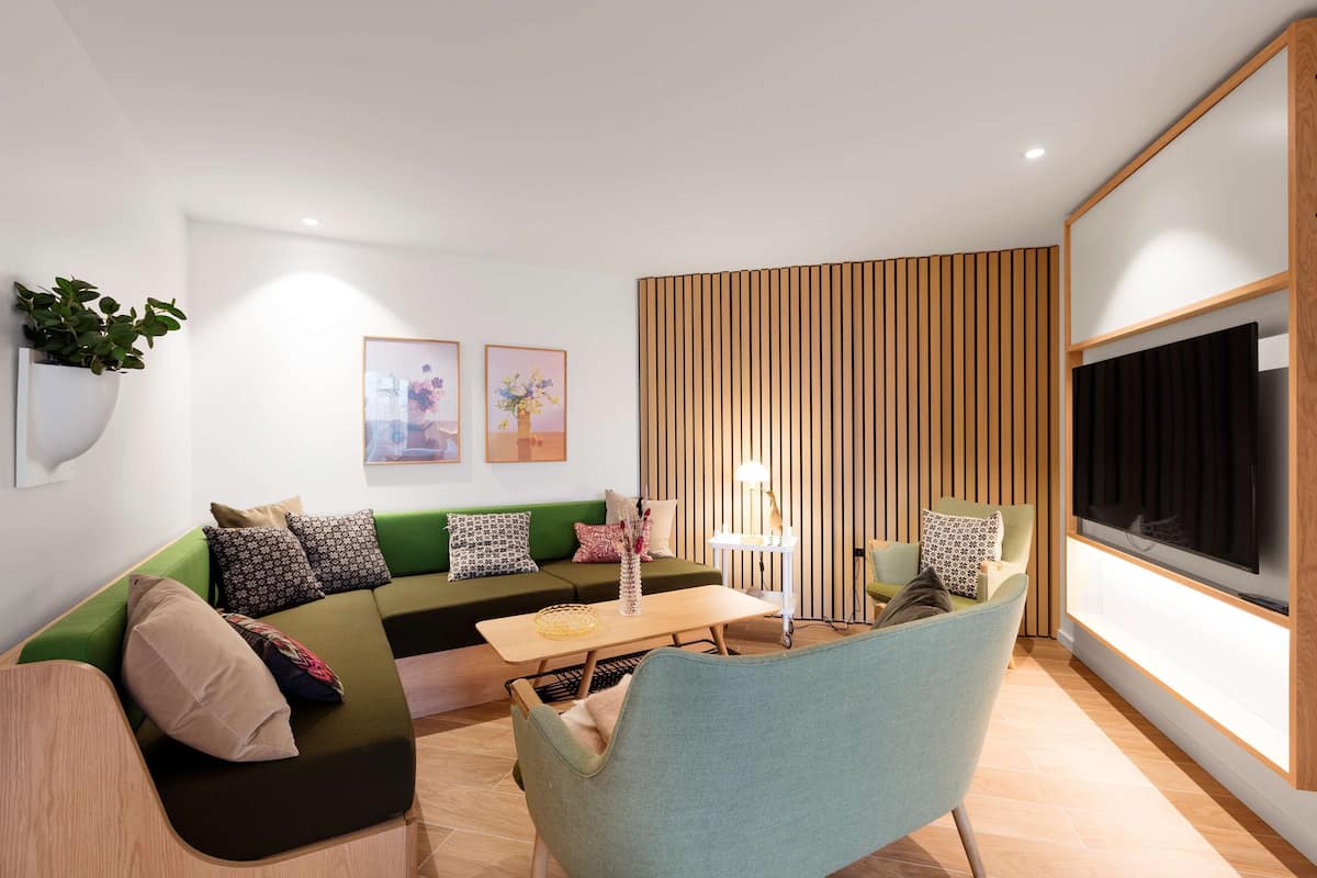 junior suite, 1 king bed | living area | 55-inch lcd tv with cable channels, tv, heated floors