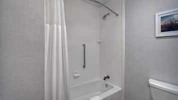 A bathroom with a bathtub, a shower, and a toilet.