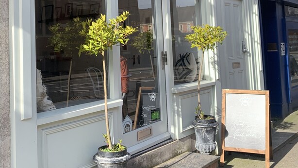 Fred's Fine Rooms English deli with a storefront, potted plants, and a chalkboard sign. - Upstairs at 33 (Worcester)