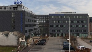A modern building with a sign reading "a&o" and "everyone can travel". - a&o Copenhagen Sydhavn - Hostel (Copenhagen)