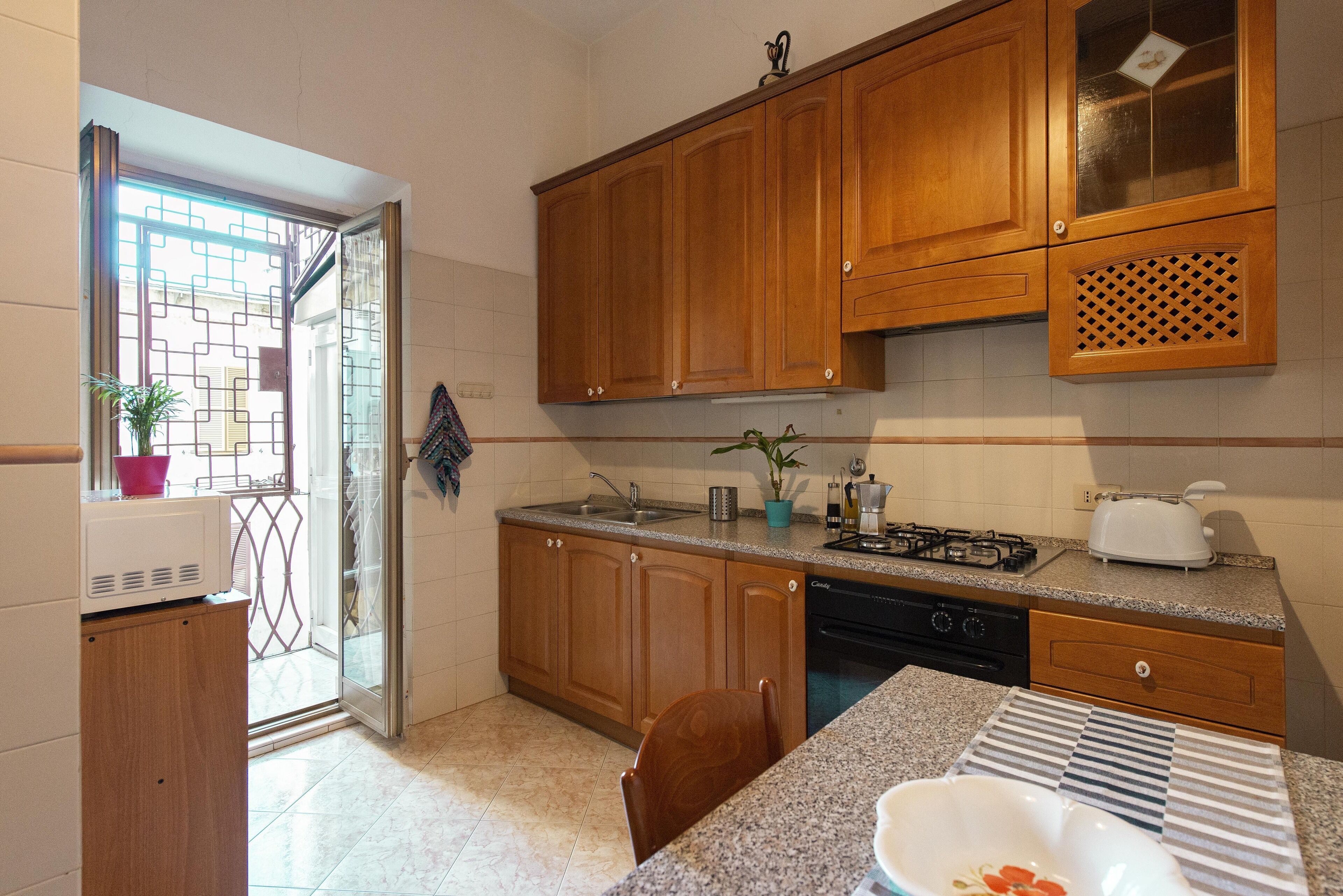 Redseven Rome Apartment | Private kitchen | Full-size fridge, microwave, oven, stovetop