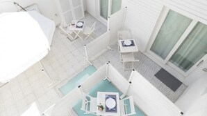 A rooftop terrace with a pool, white furniture, and a covered seating area. - Just 100 meters from one of the most beautiful and renowned beaches of the Ragusa’s coast (Marina di Ragusa)