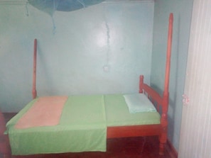 A small, single-bed room with a wooden frame and green bedding. - Silent Night Guest House (Oyugis)