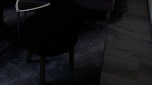 A modern bedroom with a bed, two bedside tables with lamps, a chair, and a textured wall. - Hotel La Buissonniere (Bannay)