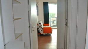 Een hotelkamer met een bed, een stoel en een raam met uitzicht.