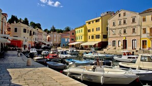 A marina with colorful buildings and boats docked.